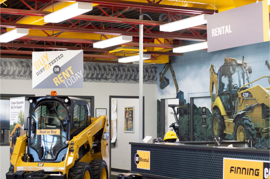 Inside of the Cat Rental Store in West Edmonton with a skidsteer on display 